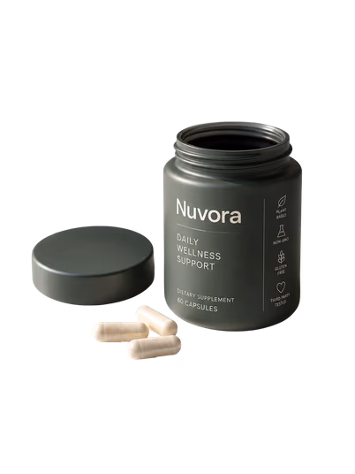 An open jar of Nuvora with a few capsules beside it
