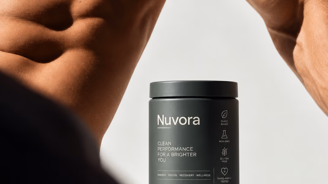 A jar of Nuvora held up between a man's arms against a pale wall