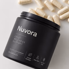 An open jar of Nuvora with capsules spilling out